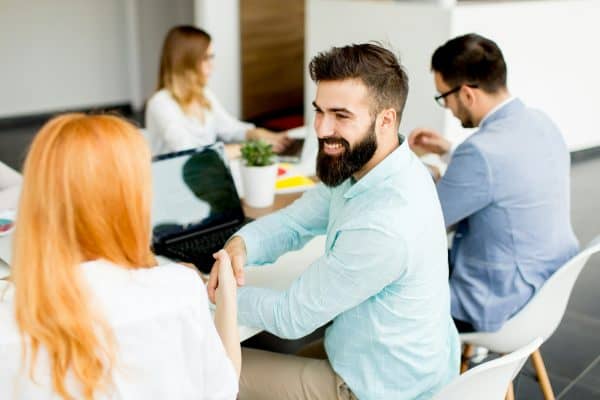 Mastering Intentionality in Networking: 1 Business people around table during staff meeting